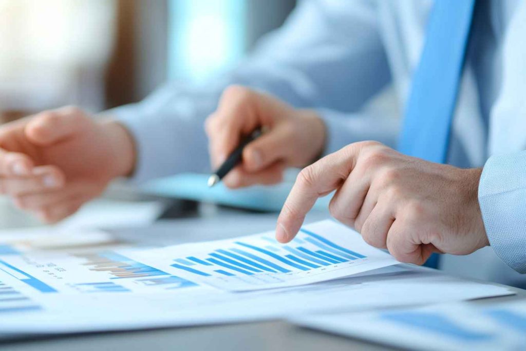 HR manager comparing multiple candidate assessment reports to make a hiring decision.
