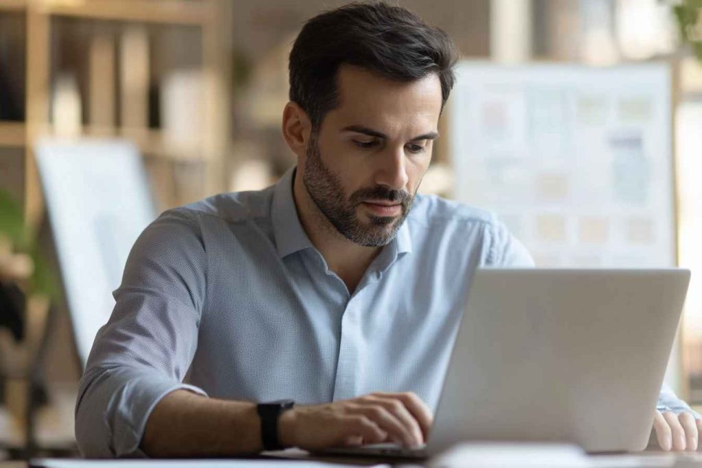 A recruiter reviewing candidate assessment questions on a laptop before an interview.