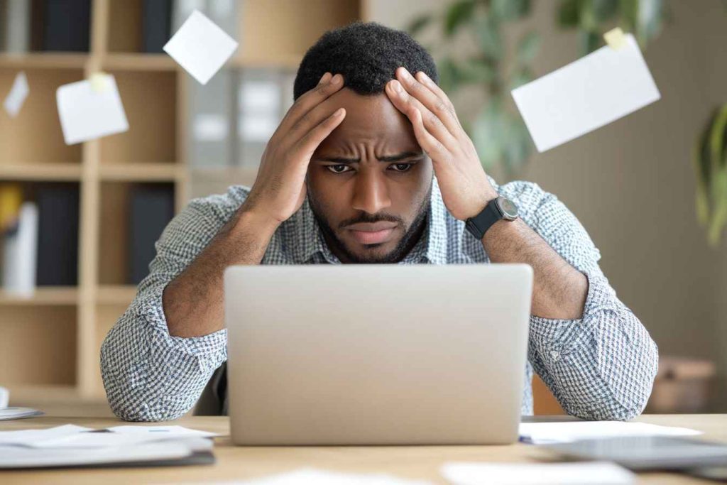 An HR manager reviewing pre-employment test results on a laptop.