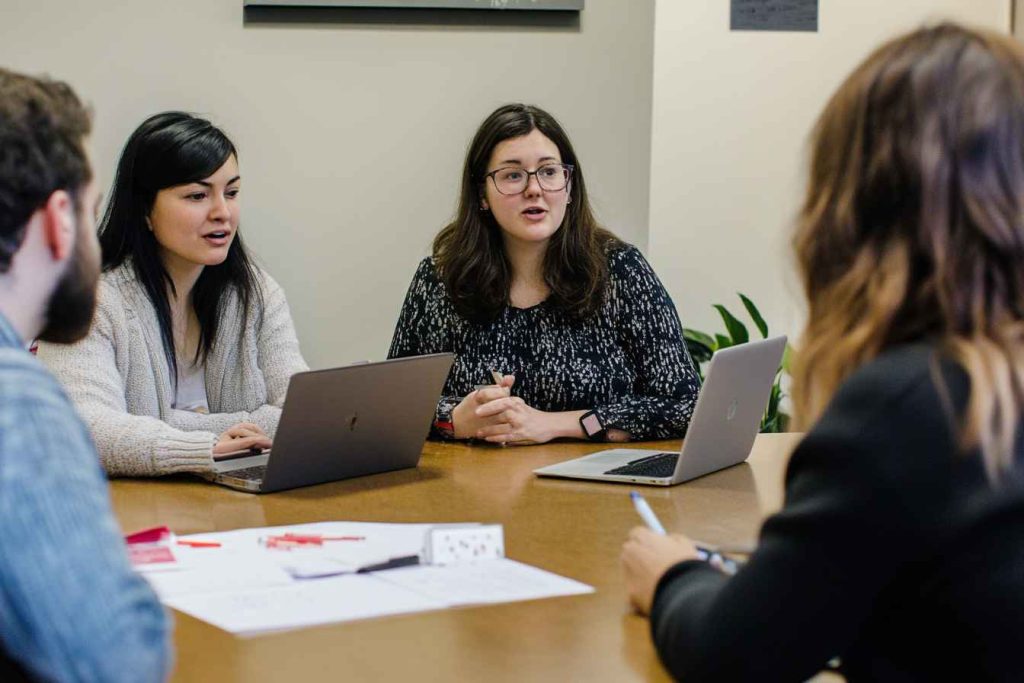 Candidate Assessment and Grading Policy and Procedure: Your Complete Guide to Fair Hiring 2 HR professionals discussing and evaluating structured candidate assessment results.