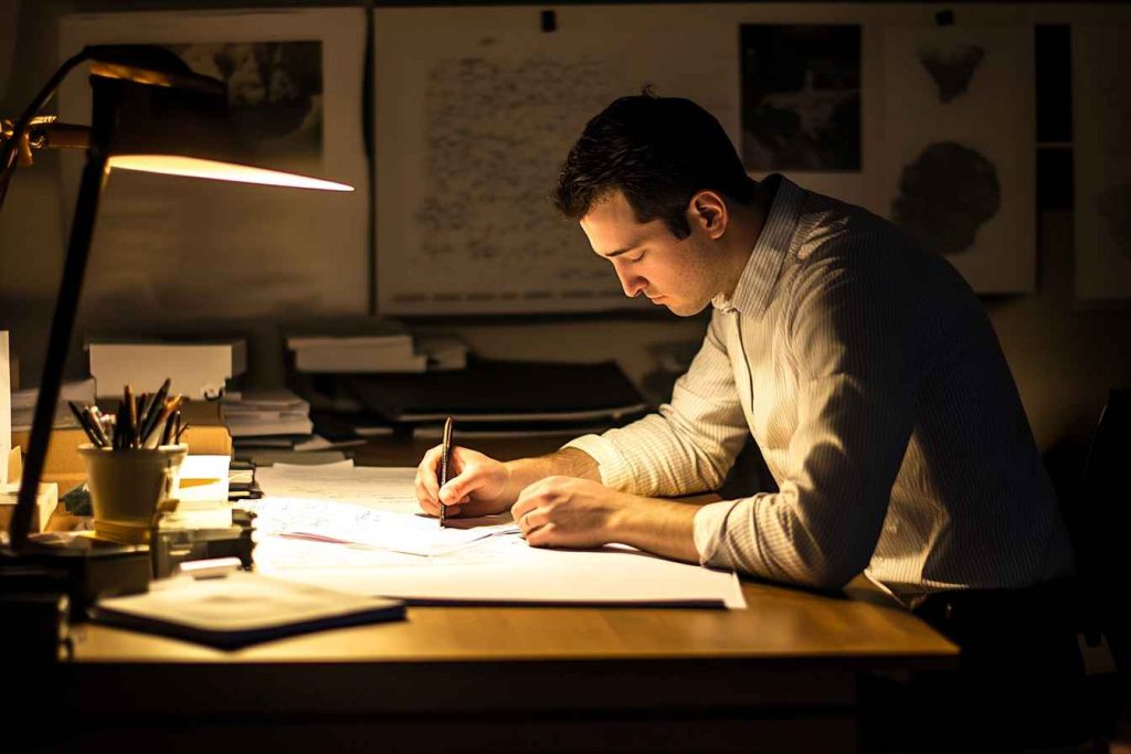 Trustworthiness in the Workplace: Meaning, Importance, Examples, and Ways to Measure 1 A male employee staying late to meet a commitment, showing reliability and trustworthiness without supervision.
