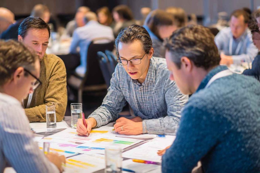 Team using printed Big Five personality tests in a workshop session