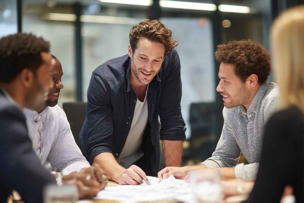 A group of colleagues discussing a candidate’s feedback report together