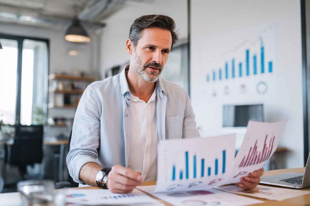 HR professional reviewing numerical reasoning test results with performance charts.