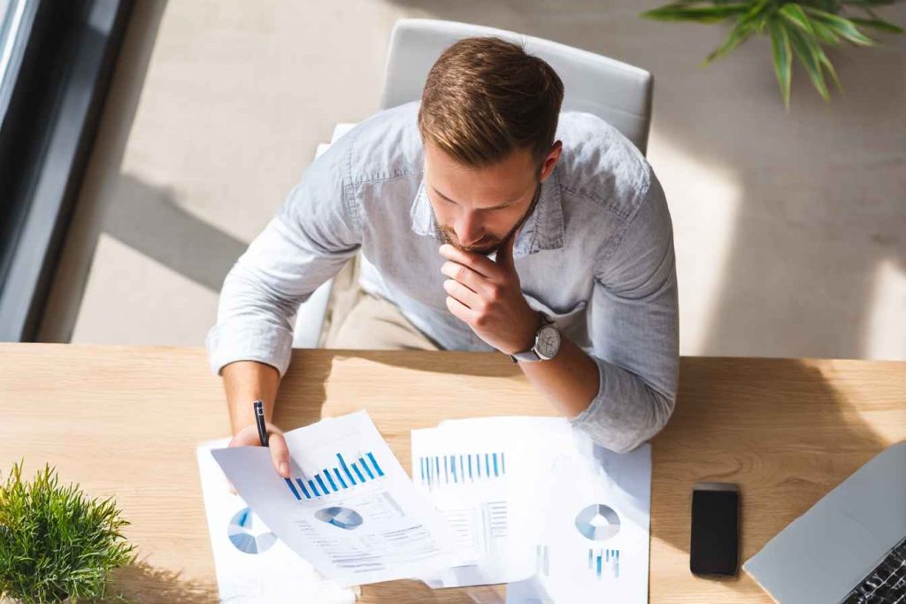 A recruiter reading a structured candidate reference report with charts and scores