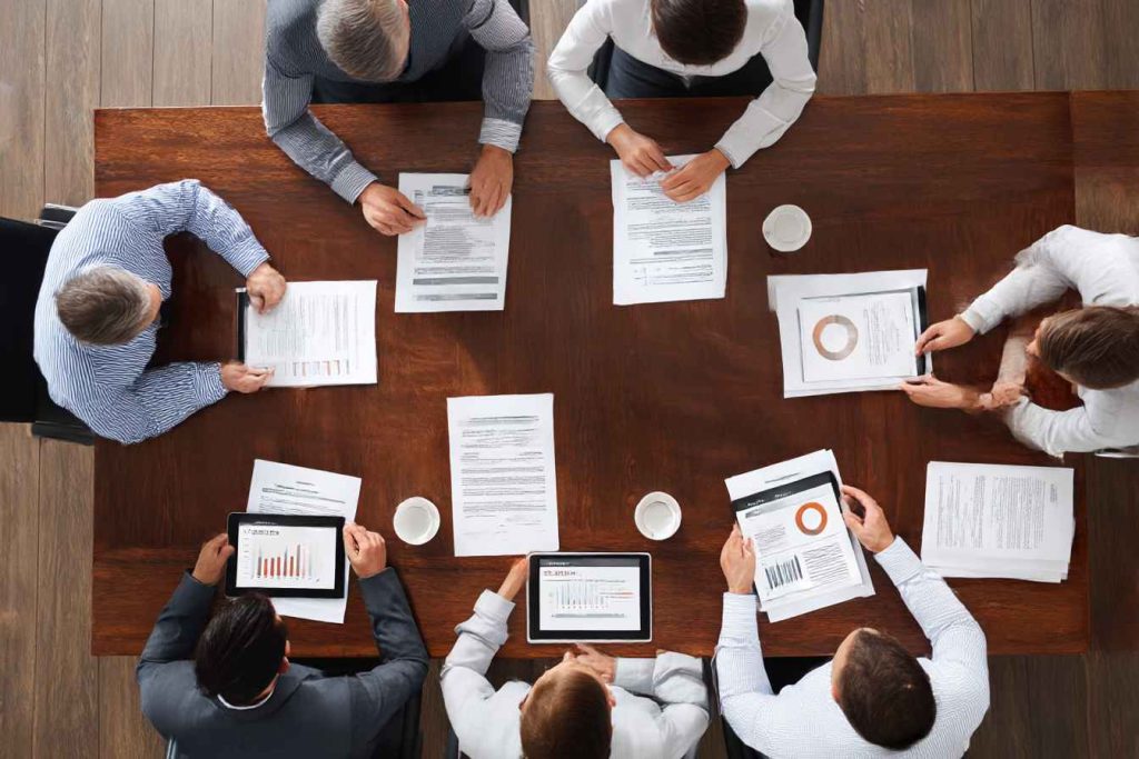 Senior executives reviewing candidate benchmark scores