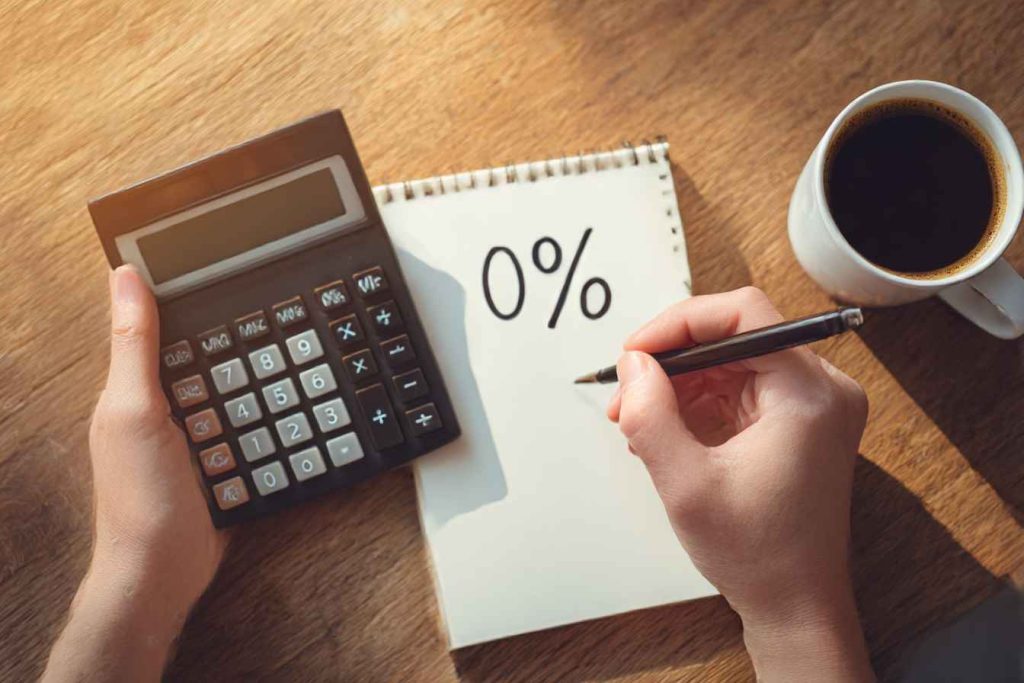 Employee calculating supplier discount on paper and calculator