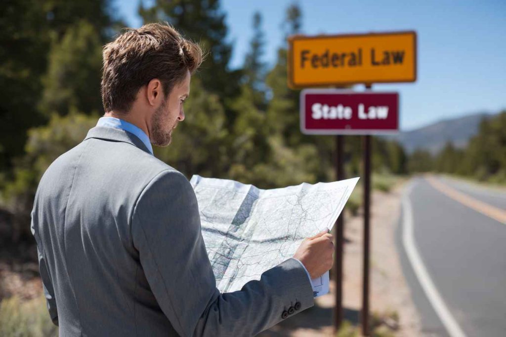 Realistic metaphor of navigating both federal and state hiring laws in the US.