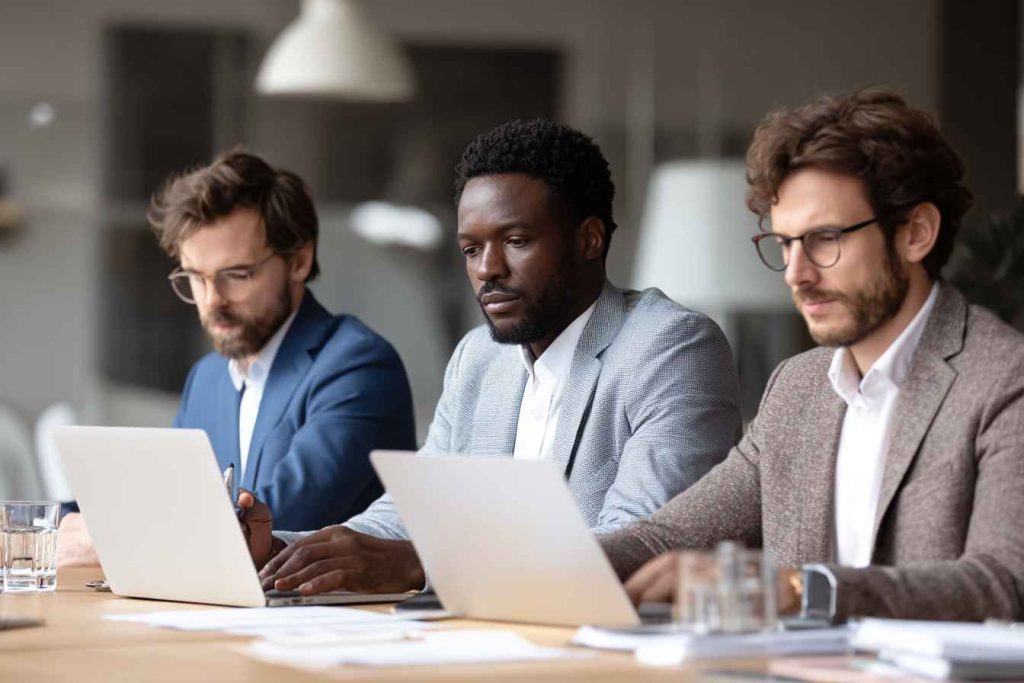 HR hiring team comparing SEO assessment results of candidates.