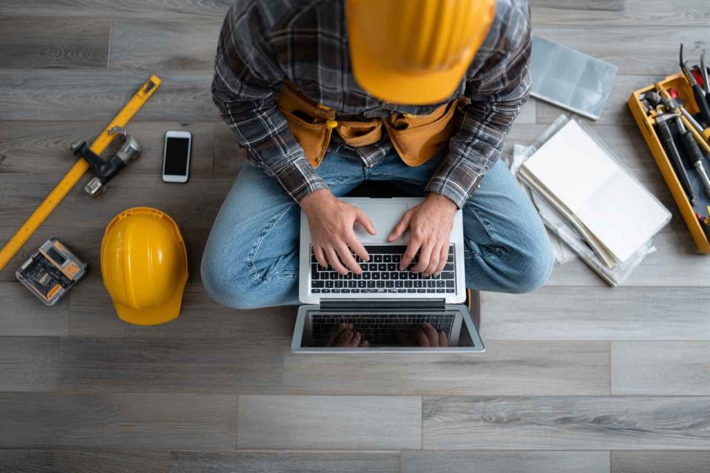 Independent contractor working remotely with personal laptop and tools.