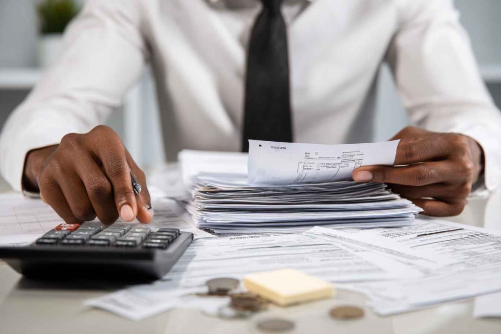 HR professional reviewing payroll documents for FLSA wage compliance.