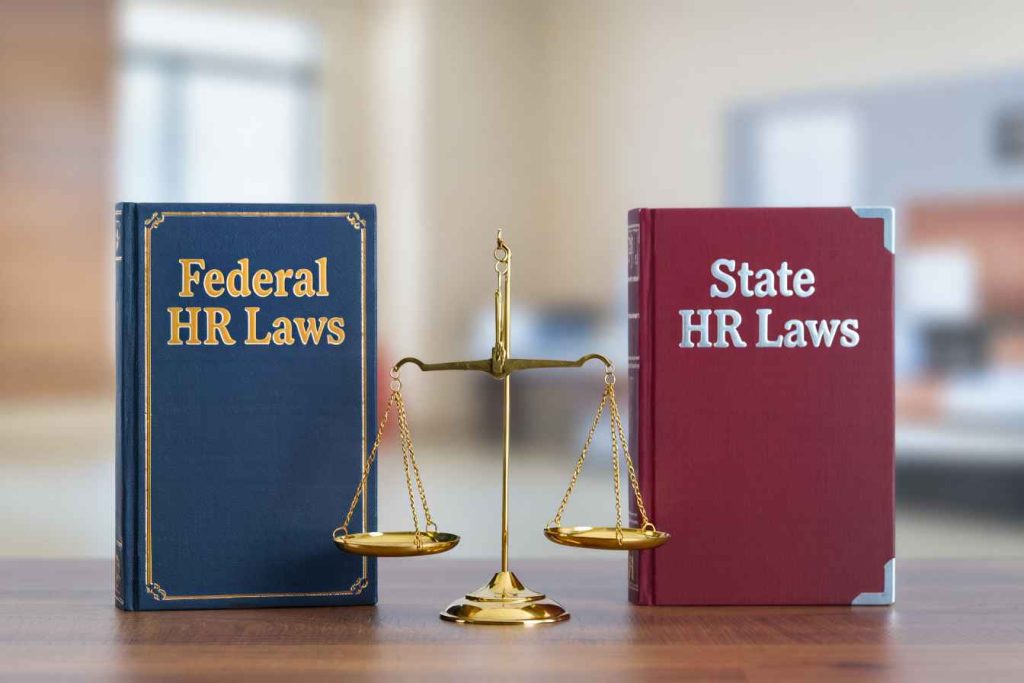 Federal and state HR law books balanced on a scale, symbolizing compliance differences.